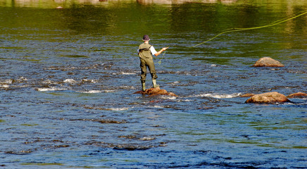 A man fishing at the river in Sweden.