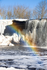 Rainbow over spring waterfall