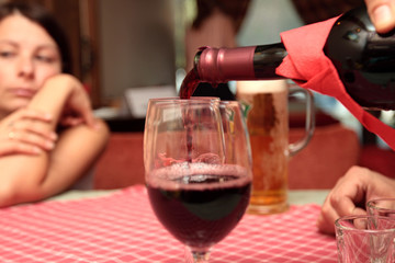 The men fills red wine