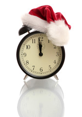 Black alarm clock in a New Year's cap 