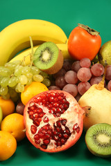 Different fruit on a green background.