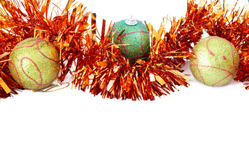 Three Christmas baubles with bright orange tinsel