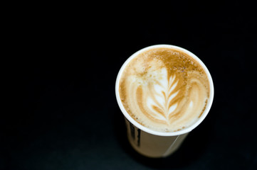 Morning cappuccino on a coffee table (black background)
