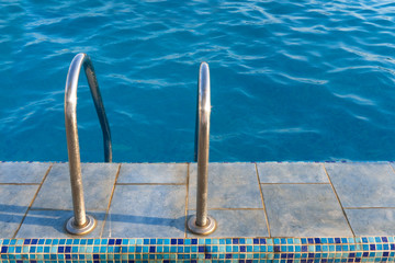 Fototapeta na wymiar Staircase to water in swimming pool