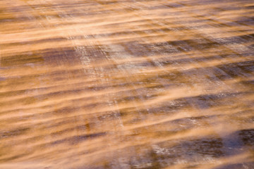 Fototapeta premium Close up of ice covered road with tire marks.