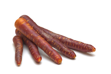 fresh black carrots on white background