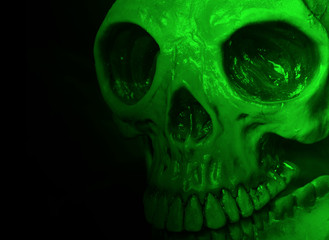 Halloween mask on black with green lighting effect