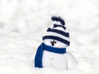 Snowman in snow on a light background