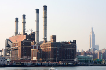 Fototapeta na wymiar power plant with nyc buildings in background