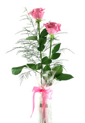 Beautiful gift arrangement of two pink roses with foliage.