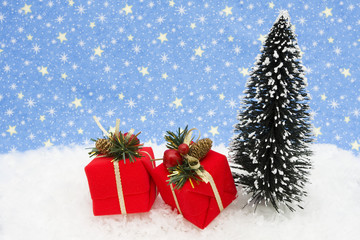 Fototapeta na wymiar Christmas tree with presents on snow with star background
