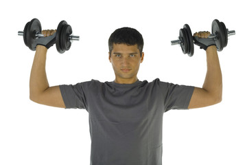 Young man exercising arms muscles with dumbbells