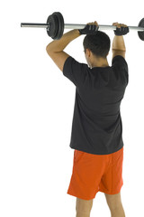 Obraz premium Young man exercising arms muscles with barbell