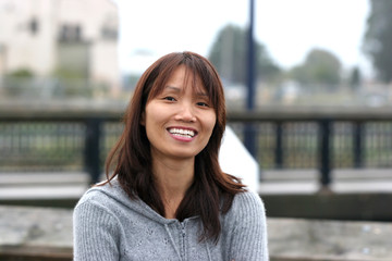 A pretty asian woman with a big smile.