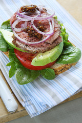 Open roast beef sandwich, on wholewheat sourdough bread.