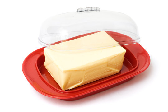 Butter on red butterdish on white background