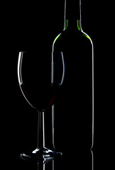 Low key shot of wine bottle and glass