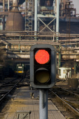 Railway signal gantry showing a red light