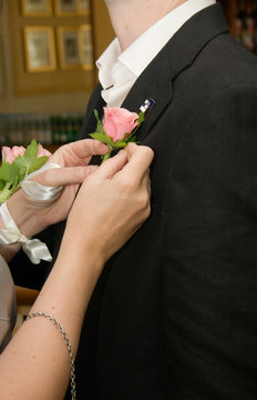 Pinning on the Groom's Buttonhole Flower