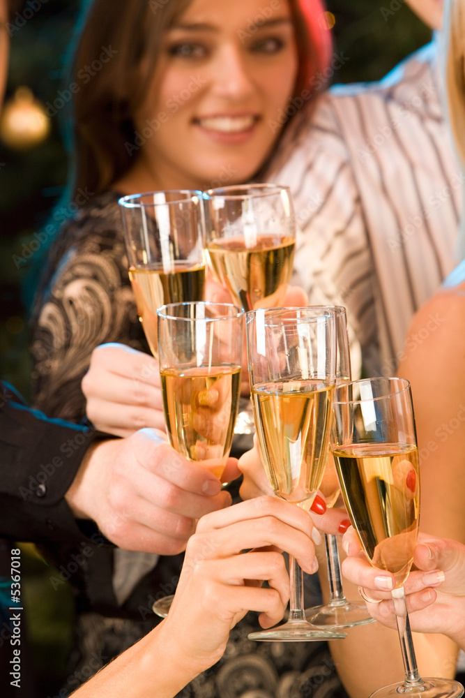 Wall mural group of champagne glasses clinking together