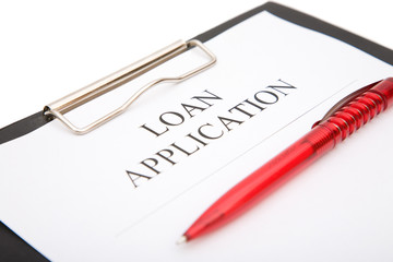 business loan application form with red pen on white background