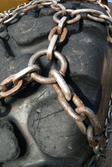 Big tire of snowplow with the chain for snow and icy