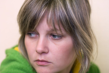 Worried looking back young woman facial close - up portret  © wildman