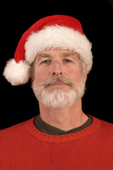 Pleasant middle-aged bearded man in a santa hat
