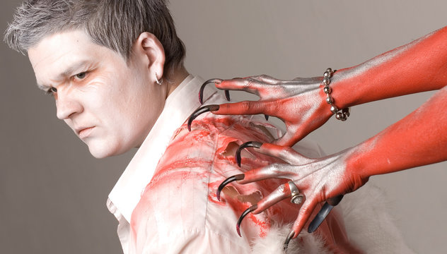 Angel and devil on a grey background