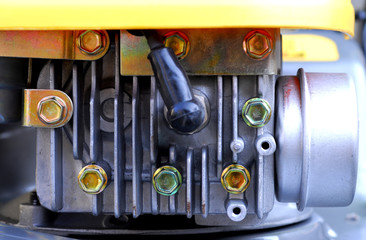a small lawn mover engine showing spark plug and exhaust