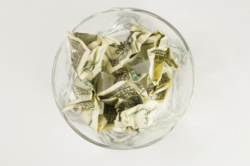 The rumpled money in a cup