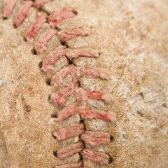 Detail of stitching on dirty worn baseball.