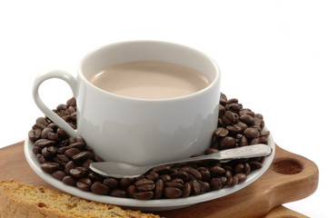 Cup of delicious latte with roasted coffee beans.