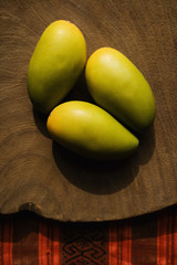Three wooden mangoes.