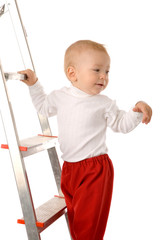 small boy in red pants on step ladder