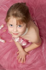Obraz na płótnie Canvas A girl in a beautiful pink dress