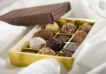 chocolate candy on silk in box close up