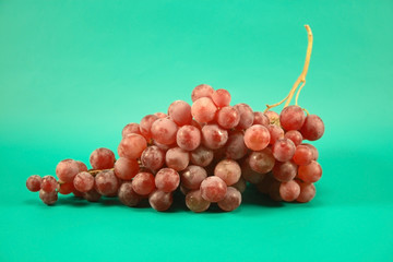 Red grapes on a green background.