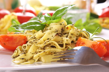 Spaghetti with pesto sauce and cheese