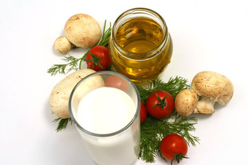 Olive oil in jar with fennel, cherry tomato, mushroom and milk