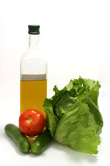 Olive oil with green lettuce, tomato and cucumber