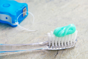 Closeup of a toothbrush and dental floss
