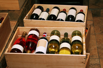 Red and white wine in bottles in wine shop