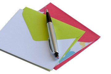 Two note cards with matching envelopes and a pen