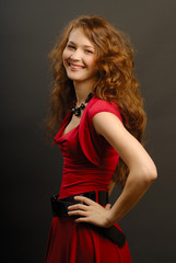 Fototapeta premium The beautiful girl in a red dress