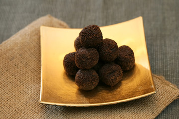 Elegant chocolates on a gold plate