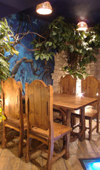 The wooden table in the corner.