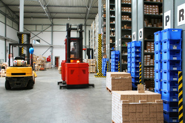Busy warehouse with pallet trucks working - 5397401