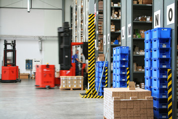 Busy warehouse with pallet trucks working - 5397402