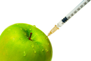 green apple and syringe isolated on white background